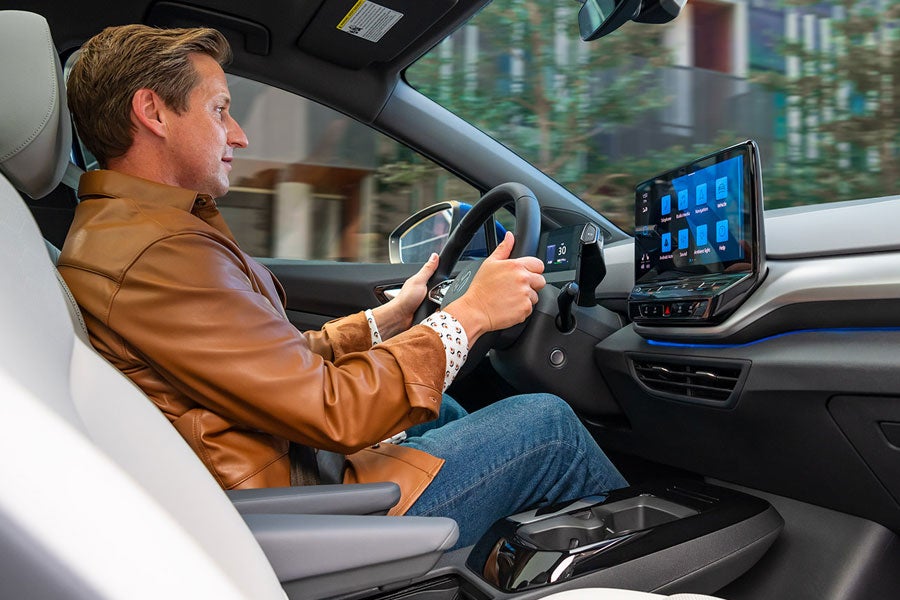 A shot of a man sitting in driver’s seat of an ID.4 with both hands on the steering wheel.